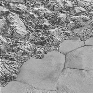 Mountains of ice along a portion of smoother ice planes on Pluto's surface.